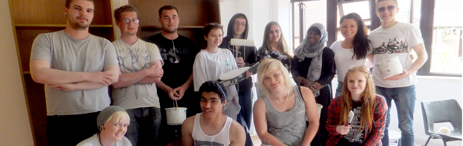 Group of young people with painting equipment.